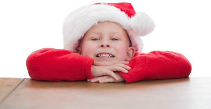 Digital png photo of happy caucasian boy in santa hat on transparent background