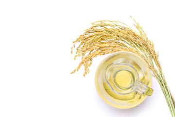 Rice bran oil extract with paddy unmilled rice isolated on white background. Top view. Flat lay.