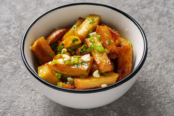 French fries close-up in a bowl with garlic and herbs