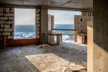 Construction of a multi-storey residential building on a sunny winter day