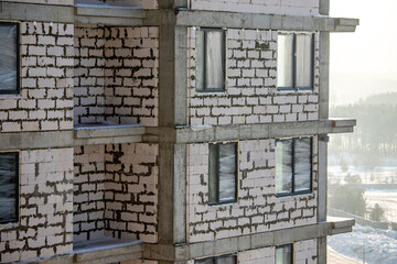 A multi-storey residential building under construction on a sunny winter day