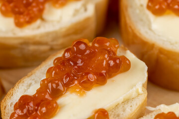 Thinly sliced baguette with salmon caviar and butter