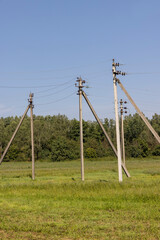 Fototapeta na wymiar High-voltage power lines mounted on concrete poles