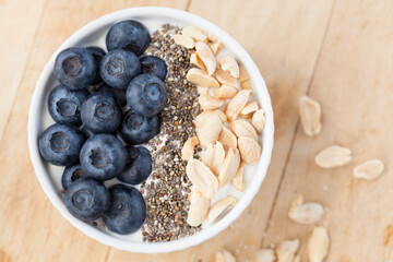 yogurt with blueberry, chia seeds and peanuts.