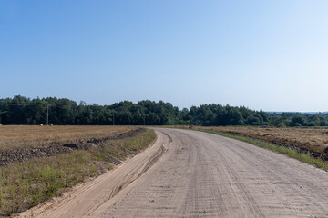 Fototapeta na wymiar Rural road for cars and transport