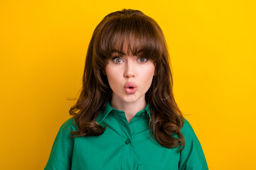 Photo of shiny adorable impressed lady wear green shirt big eyes isolated yellow color background