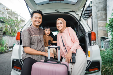 happy asian muslim family going on road trip back home during eid mubarak celebration