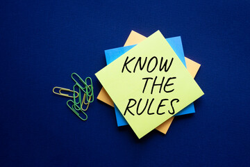 Know the rules symbol. Yellow steaky note with words Know the rules. Beautiful deep blue...