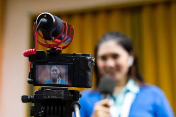 Fototapeten one set of camera recording the beautiful reporter in blue cardigan © Odua Images