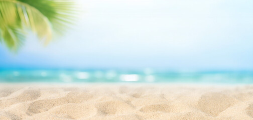 Beautiful wide paradise beach with golden sand and palm leaves in blur. Summer natur banner.