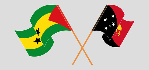 Crossed and waving flags of Sao Tome and Principe and Papua New Guinea