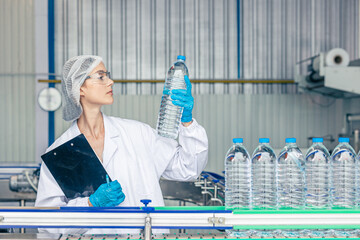 worker in drinking water factory. women workers caucasian labor in beverage clean production...