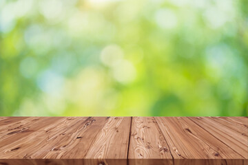 Green blur eco nature with graphic wood table blank space foreground for advertising montage background