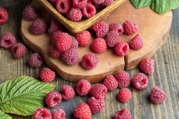 Ripe raspberries on a wooden board