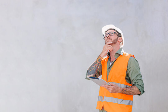 Senior engineer home builder construction worker designer architect standing thinking hand at chin expression with copy space for text