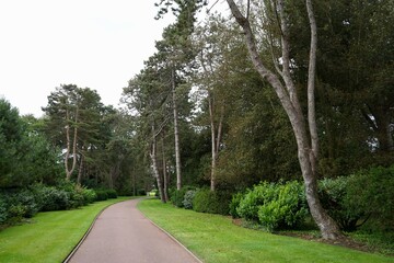 Footpath through Woods with lawns to the side at  The Normandy American Cemetery and Memorial.