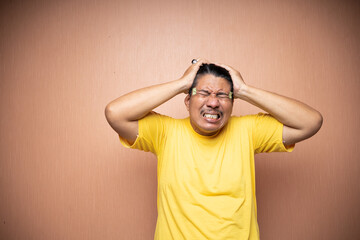 asian old man feeling headache migraine with clenching head gesture