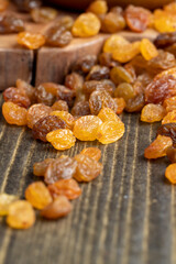 Dried yellow golden raisins on a board