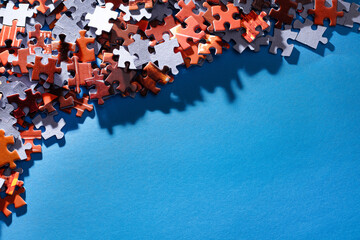 Mixed Peaces of a Colorful Jigsaw Puzzle Lie on the Blue Background With Copy Space - Strategy and Solving Problem Concept