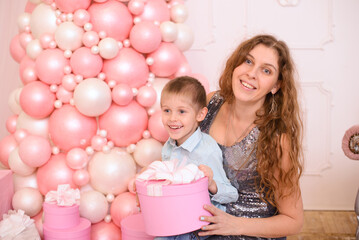 mom and son on the pink background