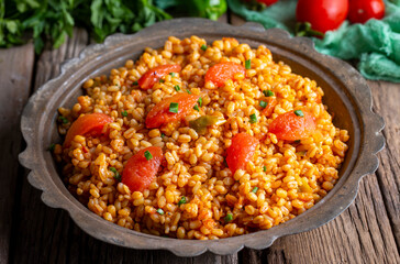 Traditional turkish bulgur pilaf with tomato sause in plate (Turkish name; meyhane pilavi)