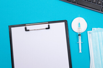 Vaccination, Immunology or Revaccination Concept - A Medical Syringe Lying on Blue Table in...