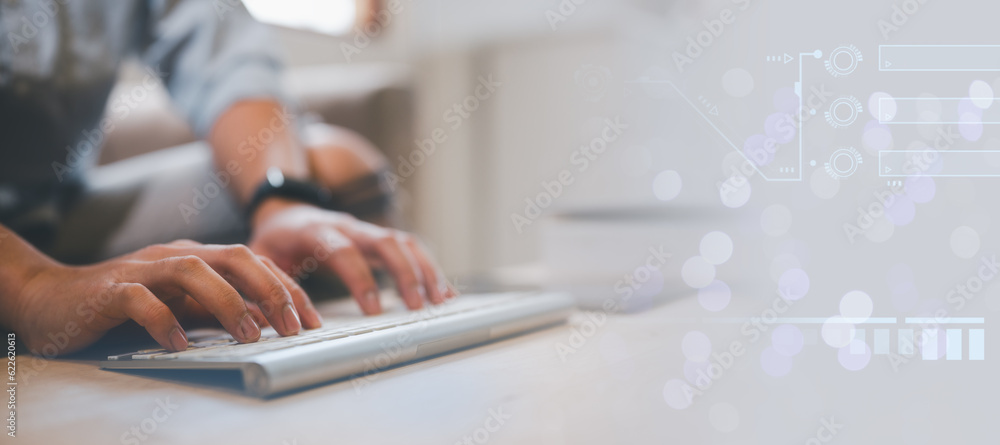 Poster man typing on wireless keyboard, sitting on couch at home, working form home concept, work online an