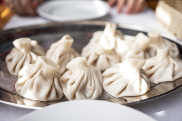Close up of khinkali is a traditional Georgian dish from the mountainous regions. Khinkali is certainly eaten with their hands, and the first thing they do is bite to drink the broth