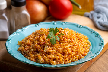 Traditional turkish bulgur pilaf with tomato sause in plate (Turkish name; meyhane pilavi)