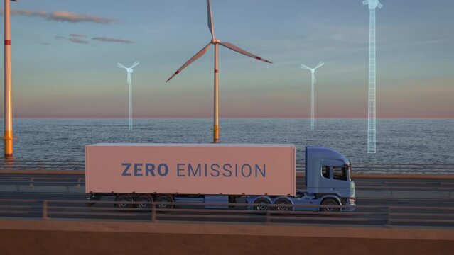 Offshore wind turbines building up behind a generic electric semi truck with cargo trailer driving along bridge into the sunset. Expansion of renewable energies. Wind farm construction. Green energy