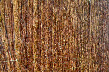 Texture of an old wooden beige table covered with a layer of cracked lacquer