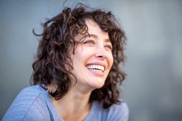 Cheerful young woman looking away and smiling