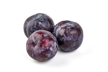 Isolated plums. One and a half of blue plum fruit with leaves isolated on white background.