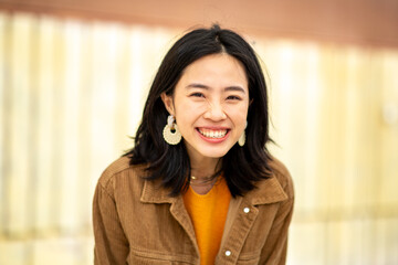 Smiling young asian woman looking at camera