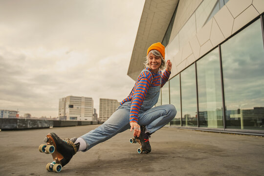 Gorgeous stylish hipster woman roller skating outdoors
