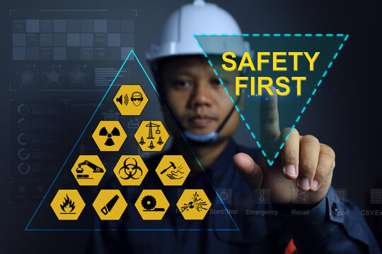 Engineers or supervisors pointing to the safety sign, safety first to remind team members to strictly follow the safety rules.