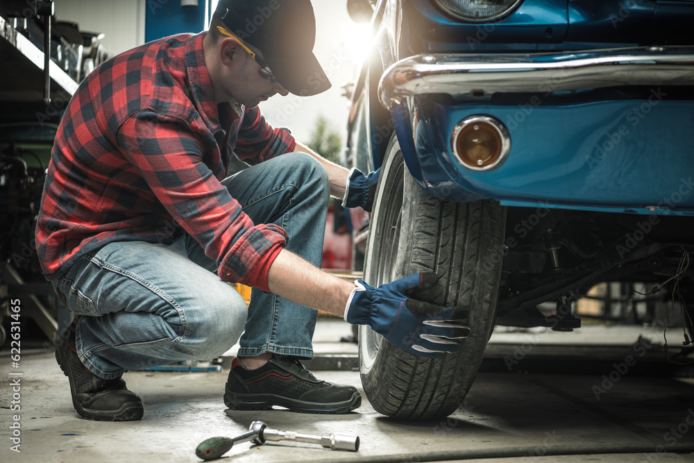 Wall mural Professional Classic Cars Restoration Worker and His Garage Project