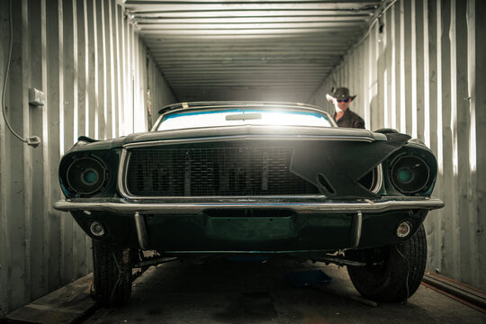 Damaged Classic American Muscle Car Inside A Shipping Cargo Container