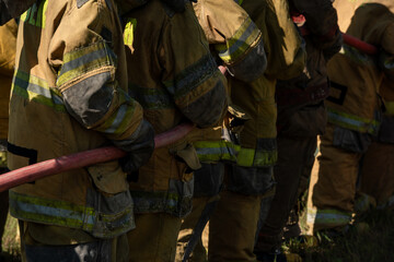 Firefighters and rescue training. Firefighter spraying high pressure water to fire Burning fire flame background