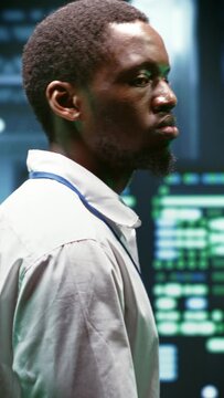 Vertical video System administrator monitoring supercomputer cybersecurity threats arising due to unsecured network connections. Supervisor making sure server hub is invulnerable to DDoS attacks