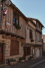 historic old village houses medieval stone brick wooden houses on street with blue skies in french village 