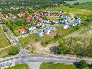 Aerial of new construction luxury residential neighborhood street single family homes real estate