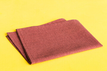 top view with red empty kitchen napkin isolated on table background. Folded cloth for mockup with...