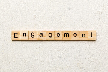 engagement word written on wood block. engagement text on table, concept