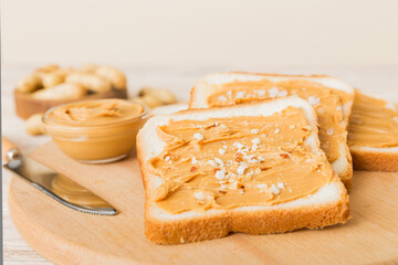 Peanut butter sandwiches or toasts on light table background.Breakfast. Vegetarian food. American cuisine top view vith copy space