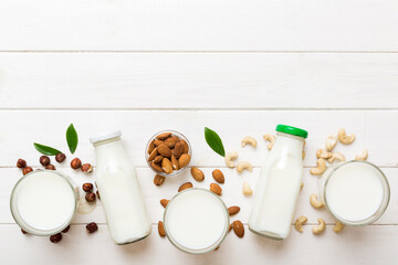 Set or collection of various vegan milk almond, cashew, on table background. Vegan plant based milk...