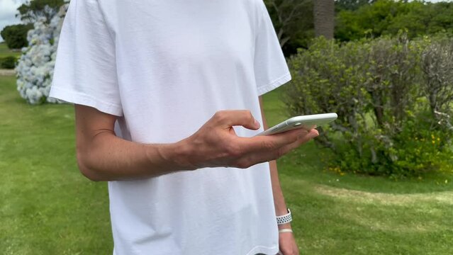 Close up view of male hands using smartphone scrolling, browsing, surfing internet, social media browsing slow motion