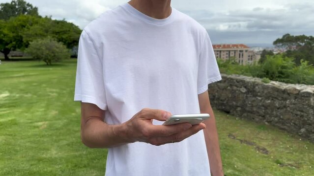 Close up view of male hands using smartphone scrolling, browsing, surfing internet, social media browsing slow motion