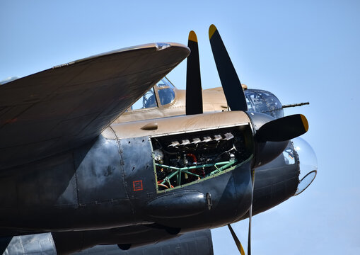 lancaster bomber raf plane details of cockpit and engine up close military base with blue skies 