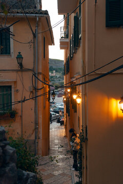 Narrow street with yellow buildings in Corfu old town, Greece